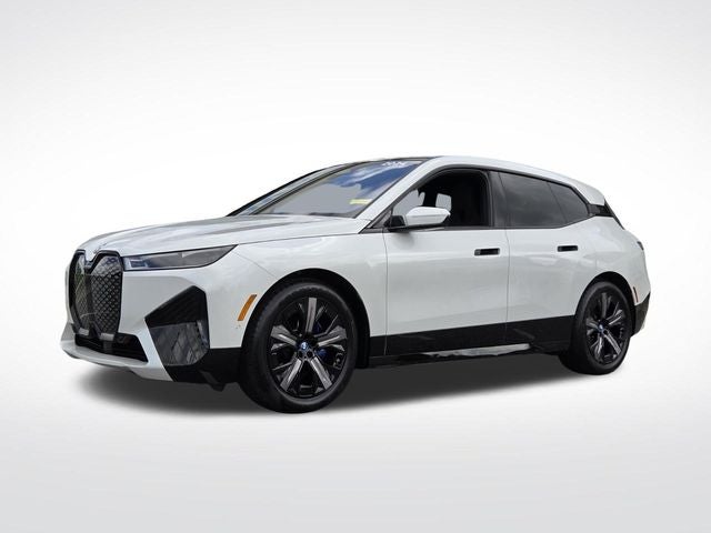 2024 BMW iX M60 in Mineral White Metallic — front three-quarter view
