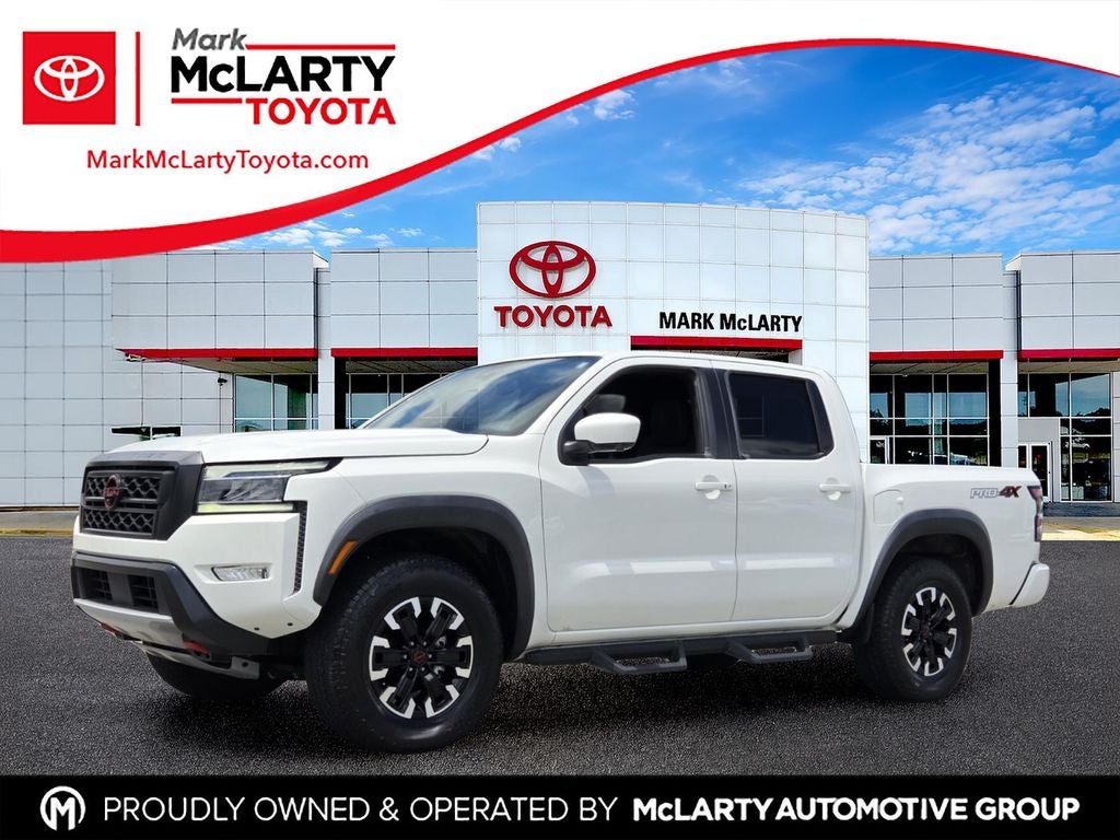 2023 Nissan Frontier PRO-4X in Glacier White — front three-quarter view