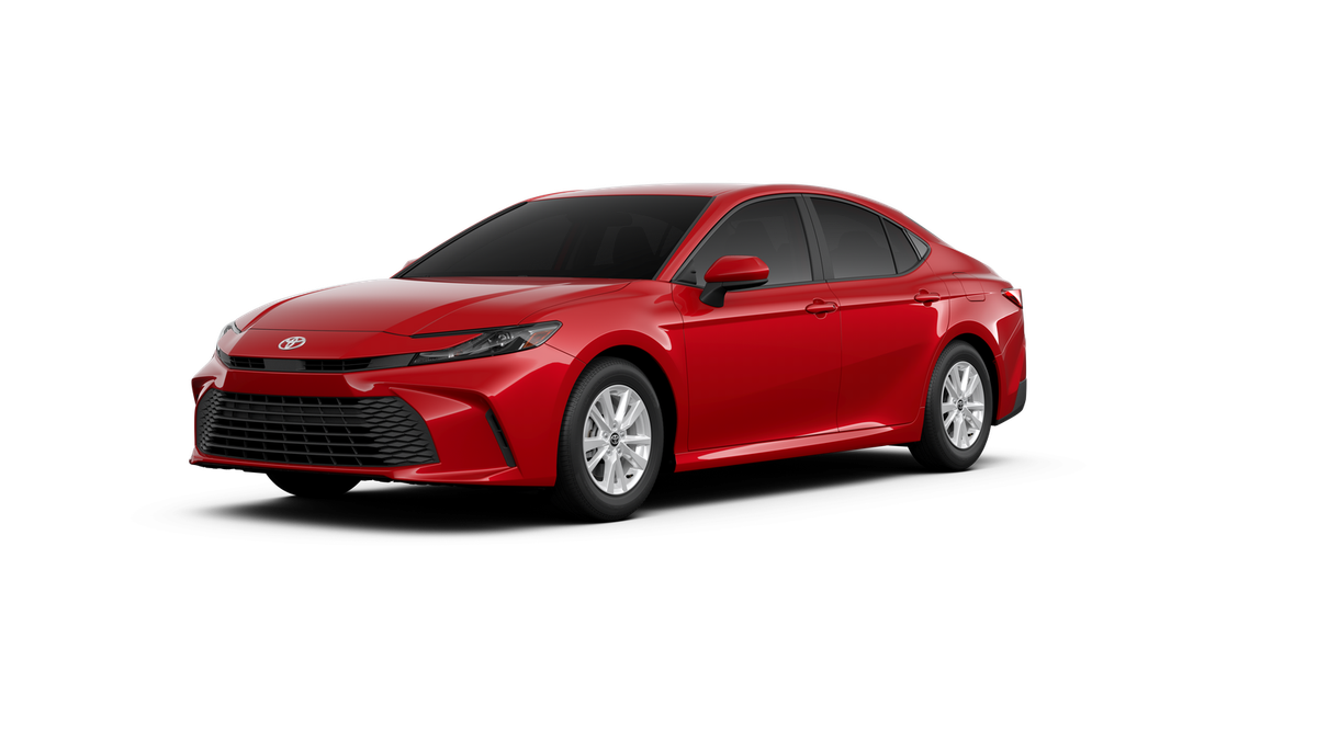 2026 Toyota Camry LE in Supersonic Red — front three-quarter view