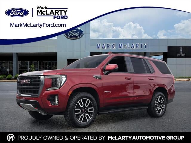 2024 GMC Yukon AT4 in Volcanic Red Tintcoat — front three-quarter view