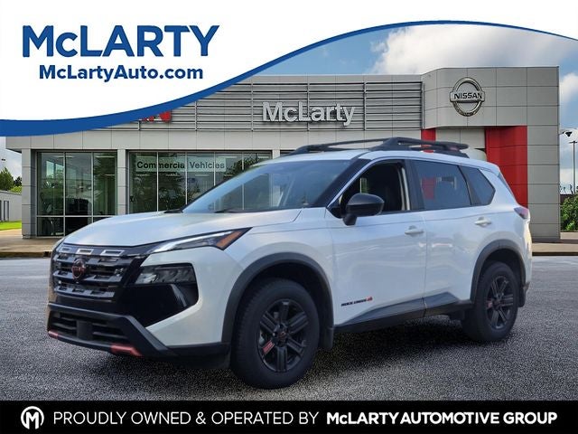 2025 Nissan Rogue Rock Creek in Everest White Pearl — front three-quarter view
